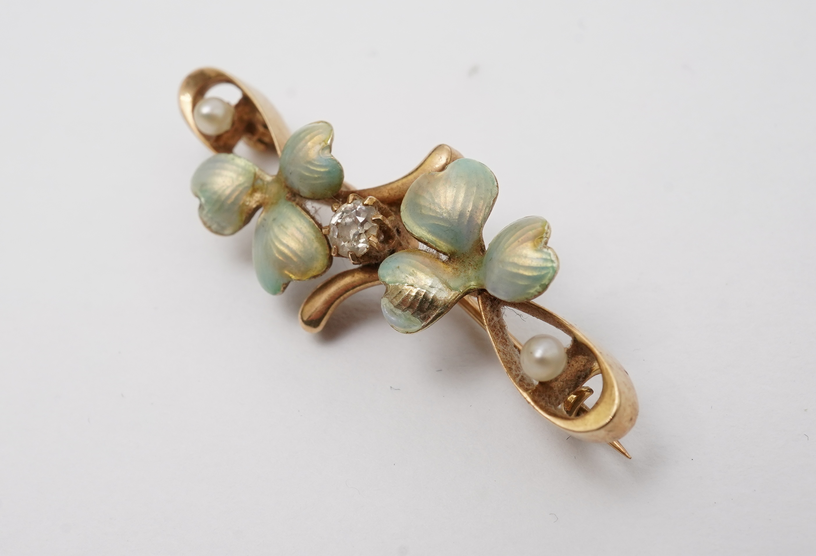 An Art Nouveau gold, enamel, seed pearl and diamond bar brooch, early 20th century